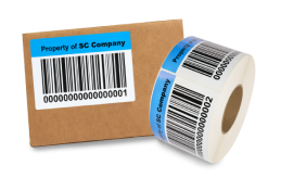 a labeled cardboard box next to a roll of labels