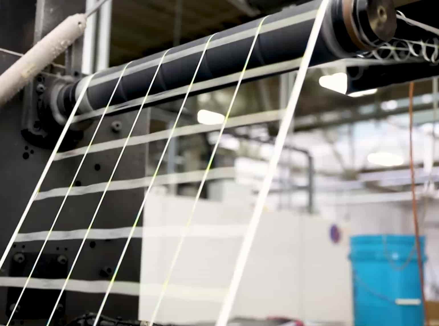 label material flowing through machines in a manufacturing workflow