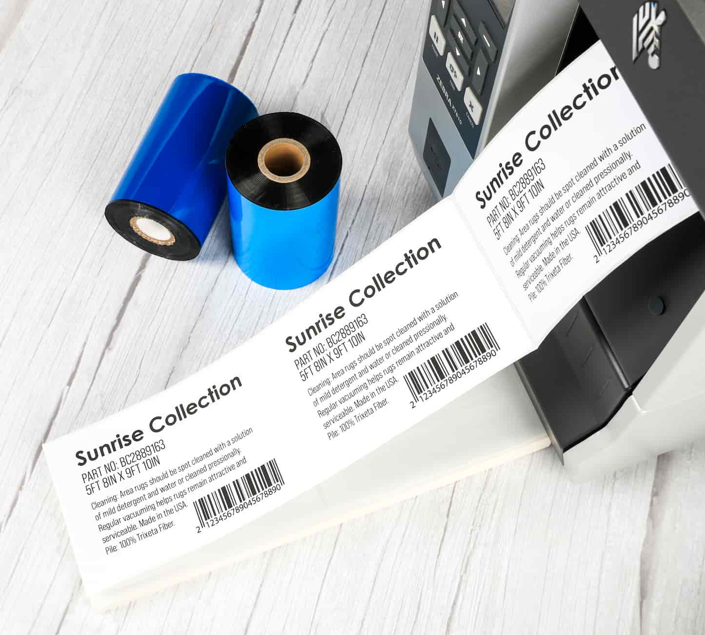 fanfold labels being printed next to 2 thermal ribbons