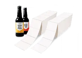 two labeled beer bottles next to a pile of fanfold labels