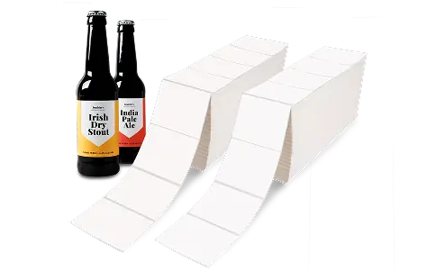two labeled beer bottles next to a pile of fanfold labels