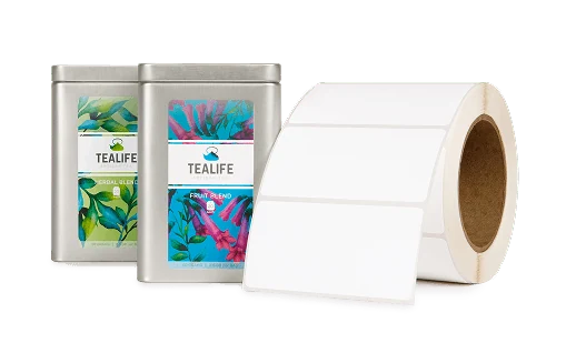 two labeled tea tins behind a roll of labels