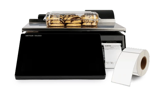 a package of cookies on a scale next to a roll of labels