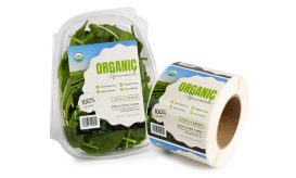 a package of spinach next to a roll of labels