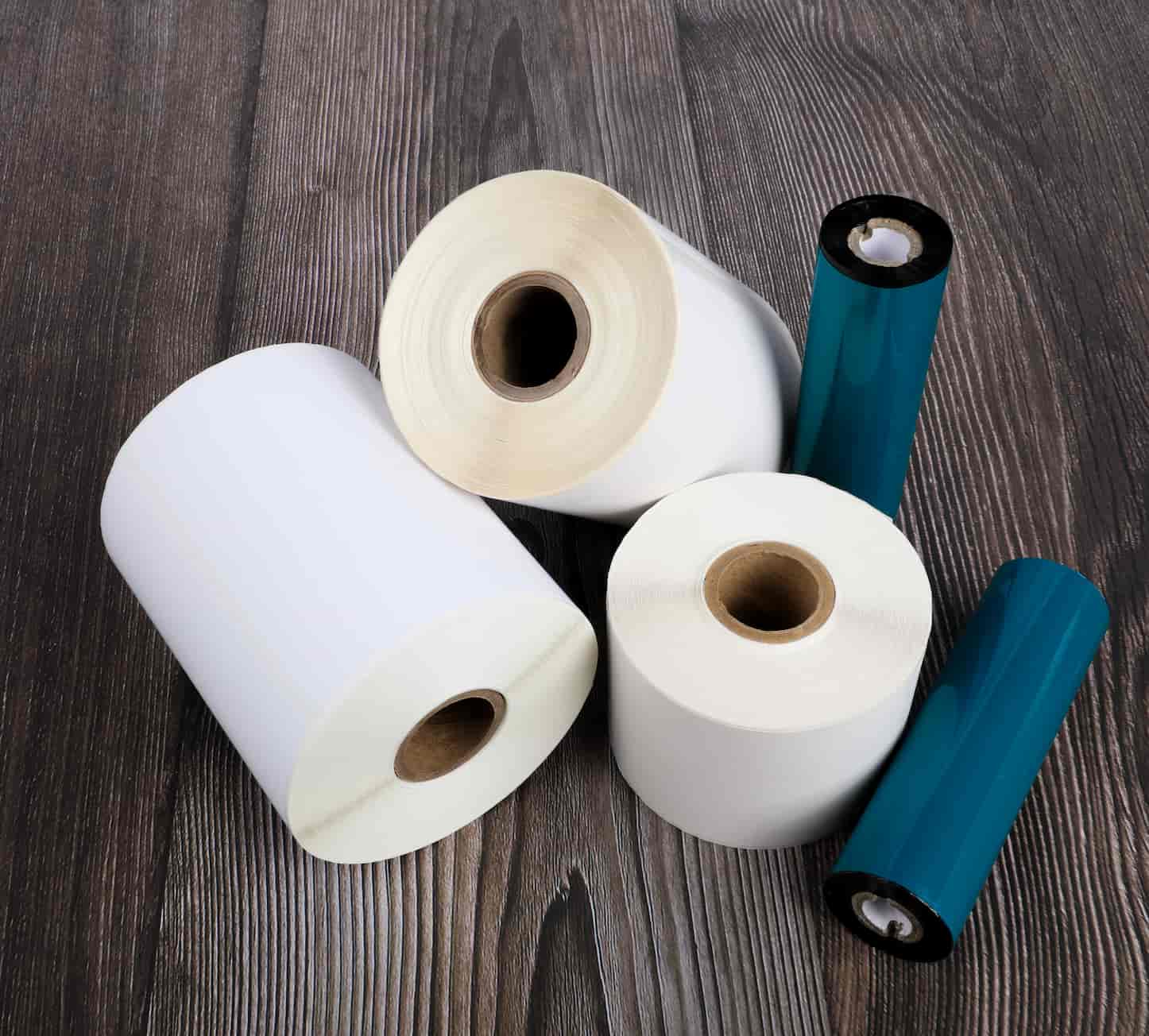 3 1 in. core rolls and 2 thermal transfer ribbons in a pile