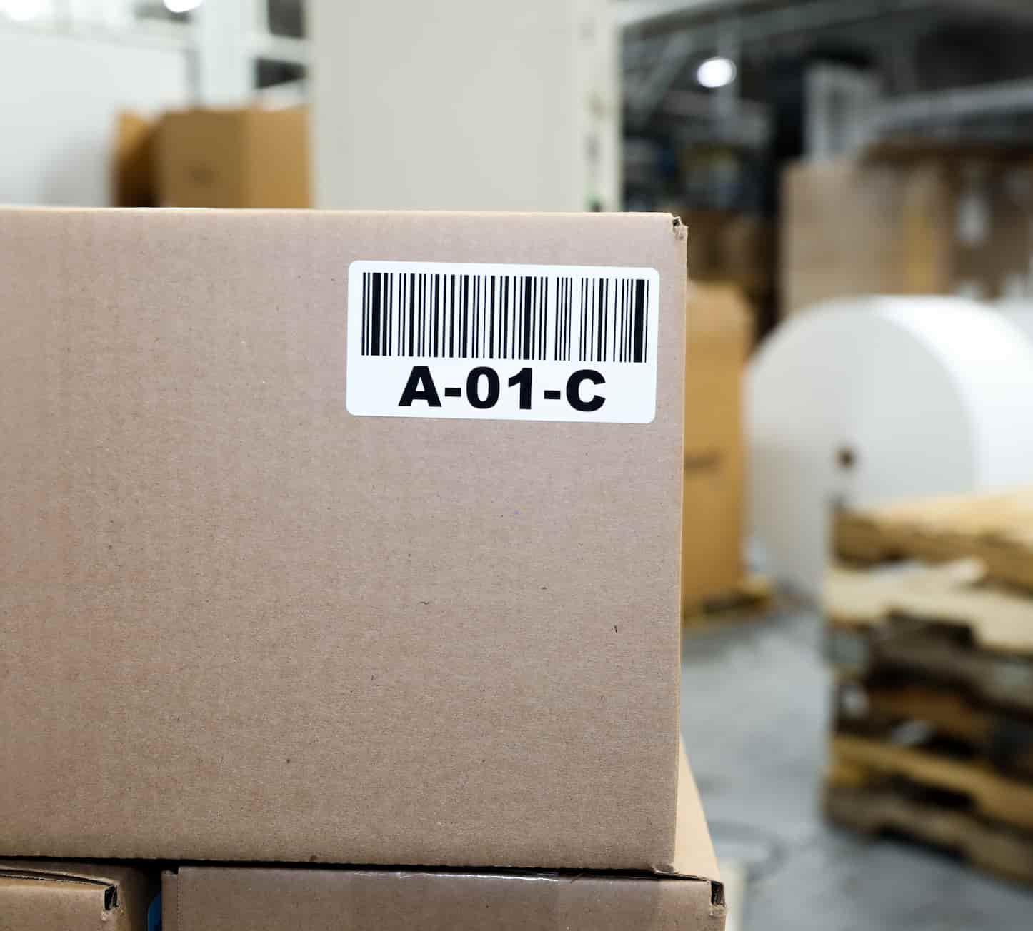 a cardboard box with a barcode label in a factory