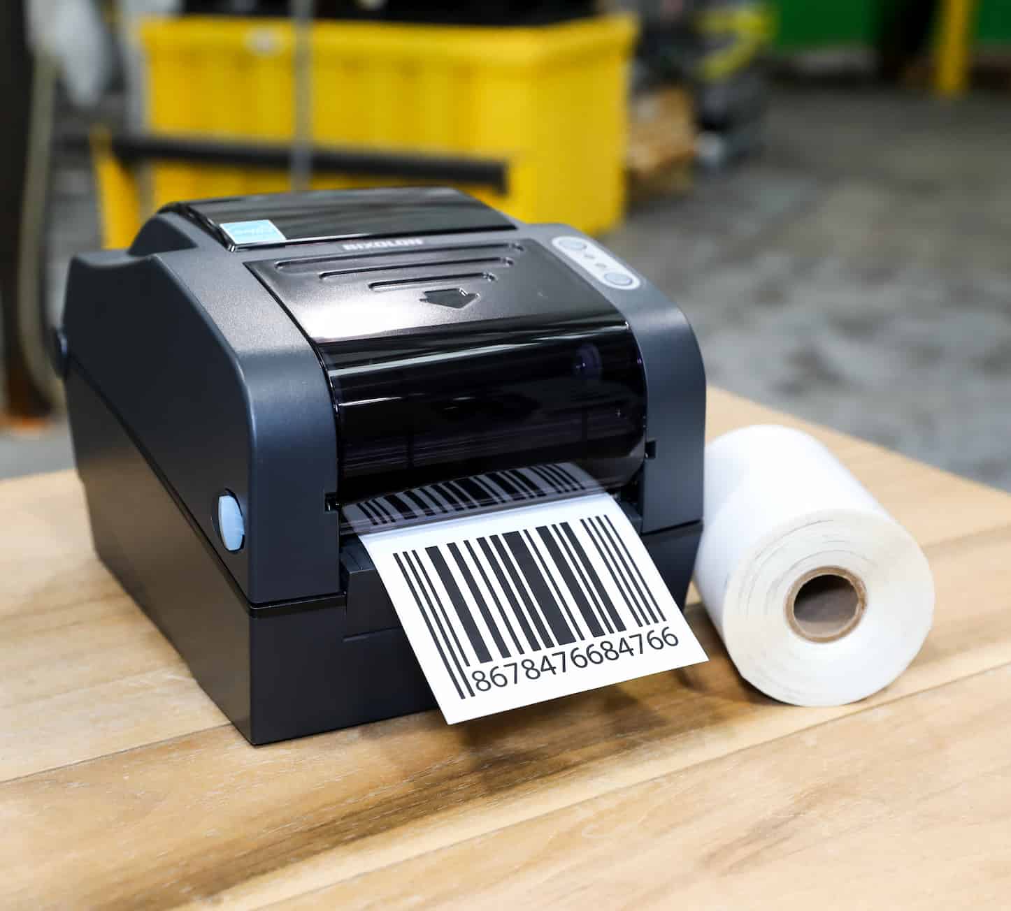 a hip printer next to a 1 in. core roll