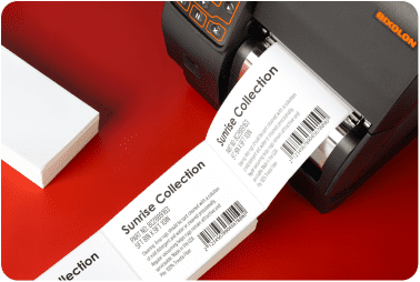 A stream of printed fanfold labels exiting a Bixolon thermal transfer printer