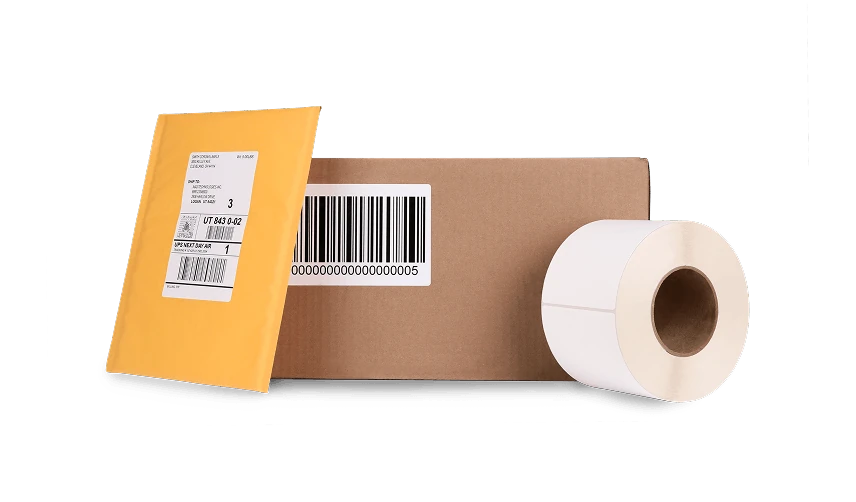 a labeled mailer, labeled cardboard box, and a roll of labels