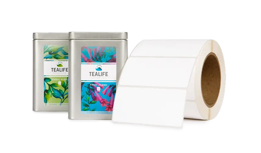 two labeled tea tins, to the right is a blank roll of inkjet labels
