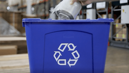 PET liner being placed into a blue recycling bin