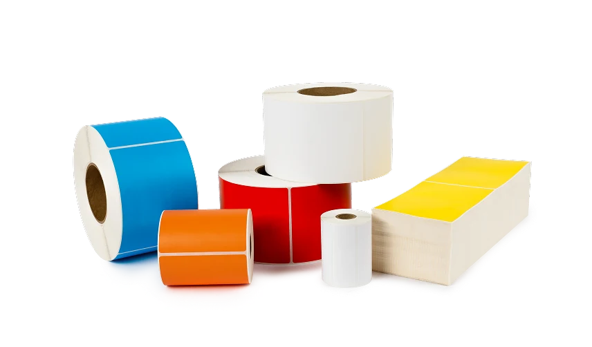 a pile of differently colored direct thermal labels and ribbons