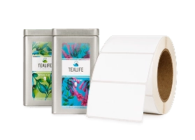 two labeled tea tins behind a roll of labels