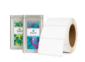 two labeled tea tins, to the right is a blank roll of inkjet labels