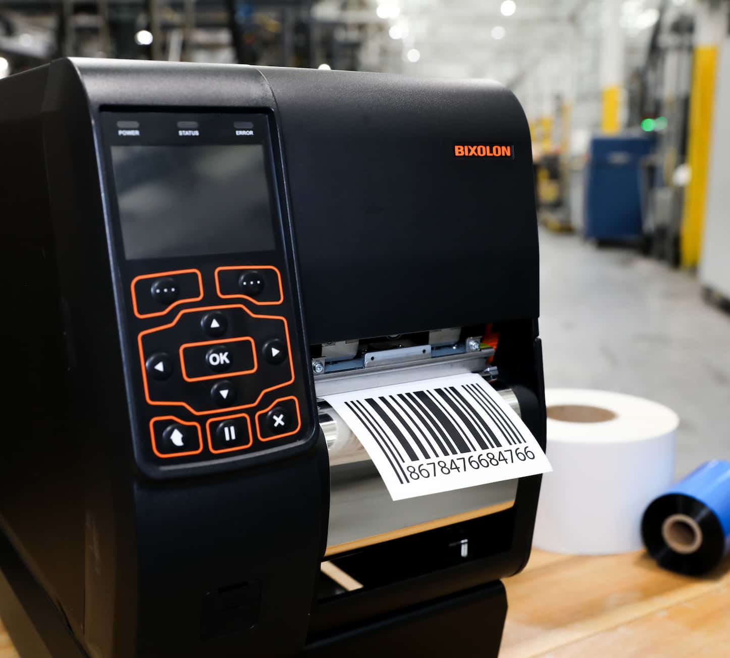 a printer on a table with a barcode label sticking out