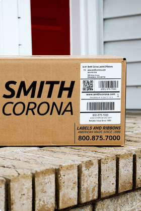 A Smith Corona package sitting on the front stoop of a house