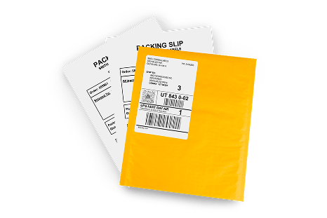 a cardboard box next to a roll of sealing tape, atop the box is a tape gun