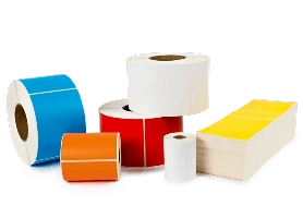 a pile of differently colored direct thermal labels and ribbons