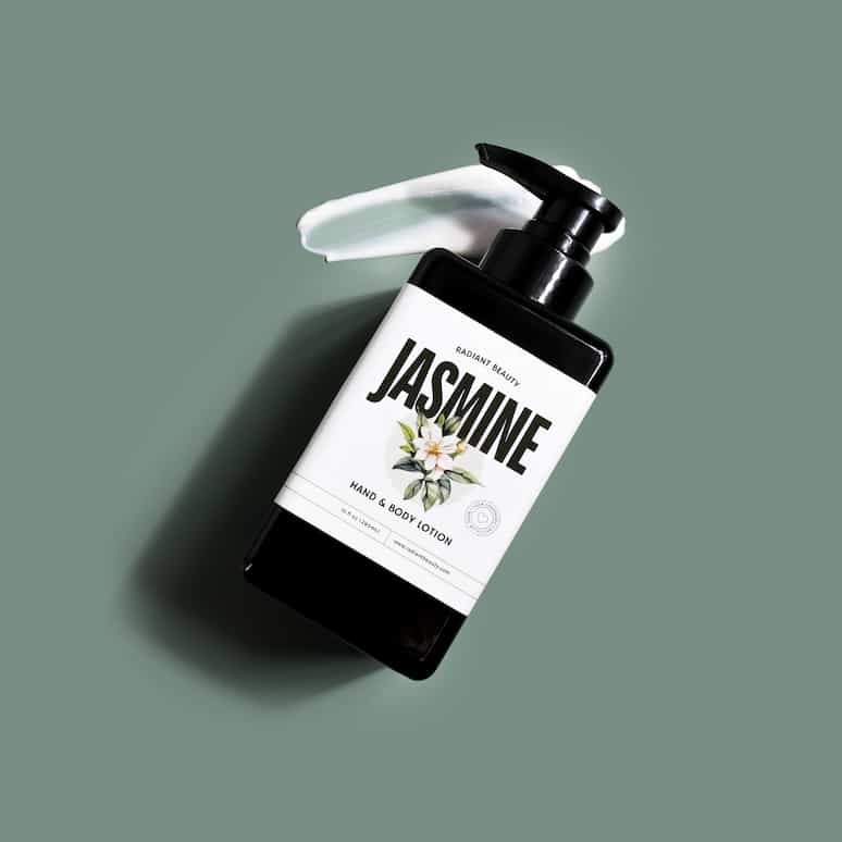 a bottle of jasmine lotion sitting on a smear of the lotion