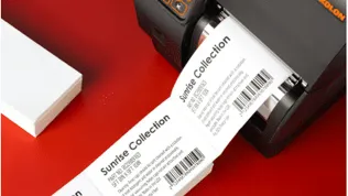 A stream of printed fanfold labels exiting a Bixolon thermal transfer printer