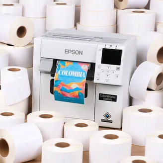 An Epson ColorWorks D3800 printer surrounded by blank label rolls